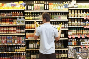 man deciding on grocery product