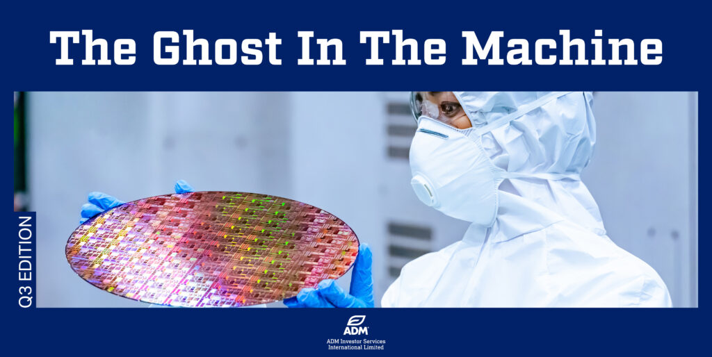 Technician in a cleanroom suit inspecting a semiconductor wafer in a high-tech manufacturing facility.
